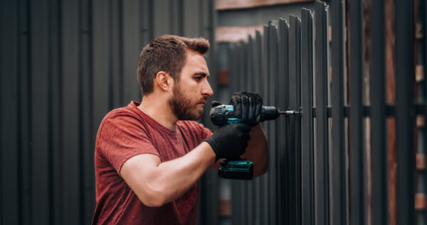 Dingers Roofing Contractor Installing Metal Fence In Wichita Ks
